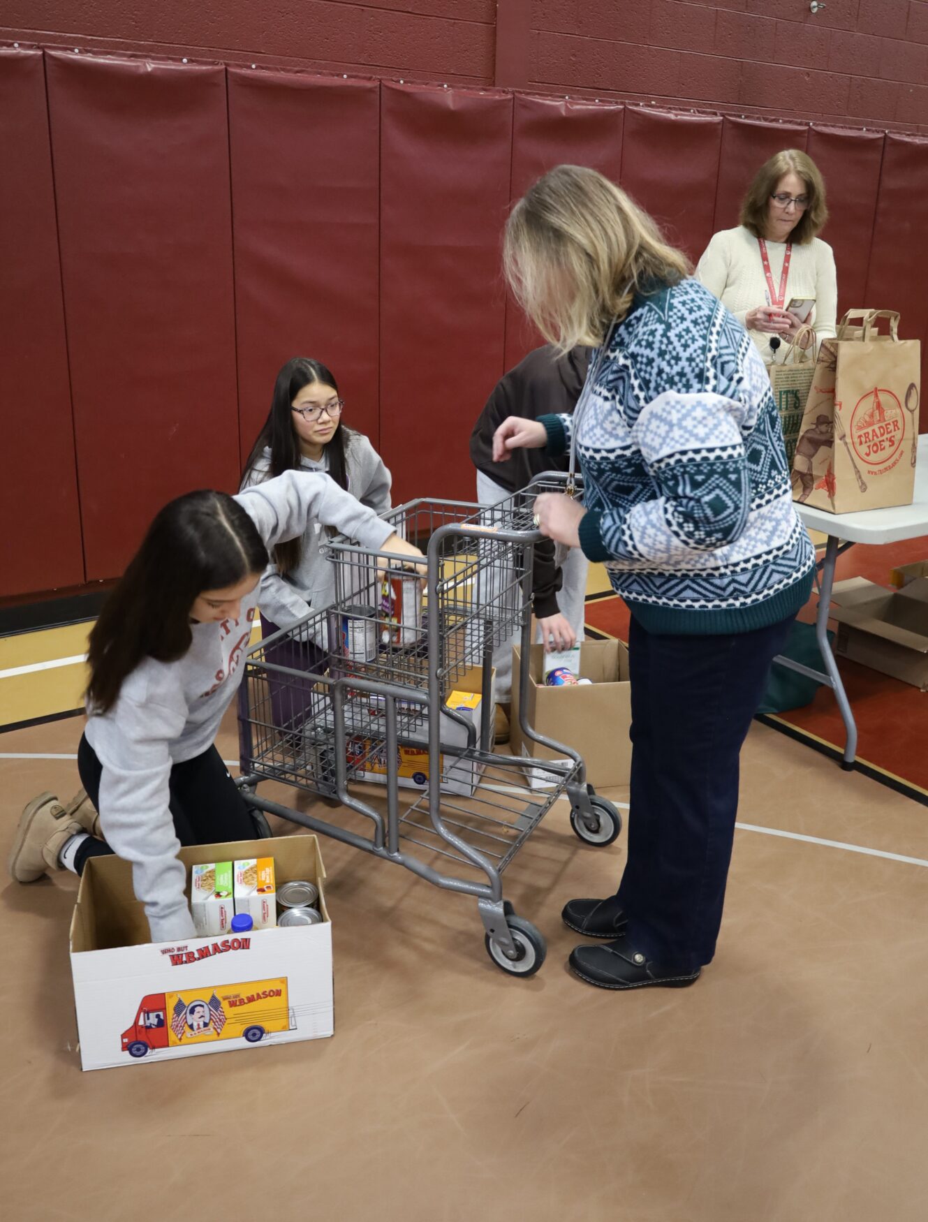 Students and staff bring in non-perishable food items for the annual Project 300 donation drive at McCarthy Middle School in Chelmsford on Thursday, January 15, 2026.
