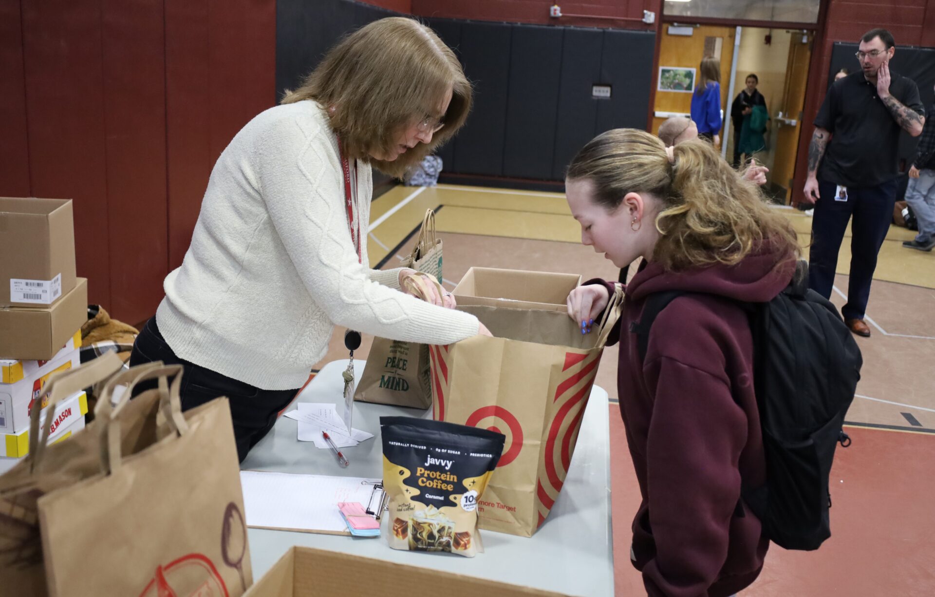 Students bring in non-perishable food items for the annual Project 300 donation drive at McCarthy Middle School in Chelmsford on Thursday, January 15, 2026.
