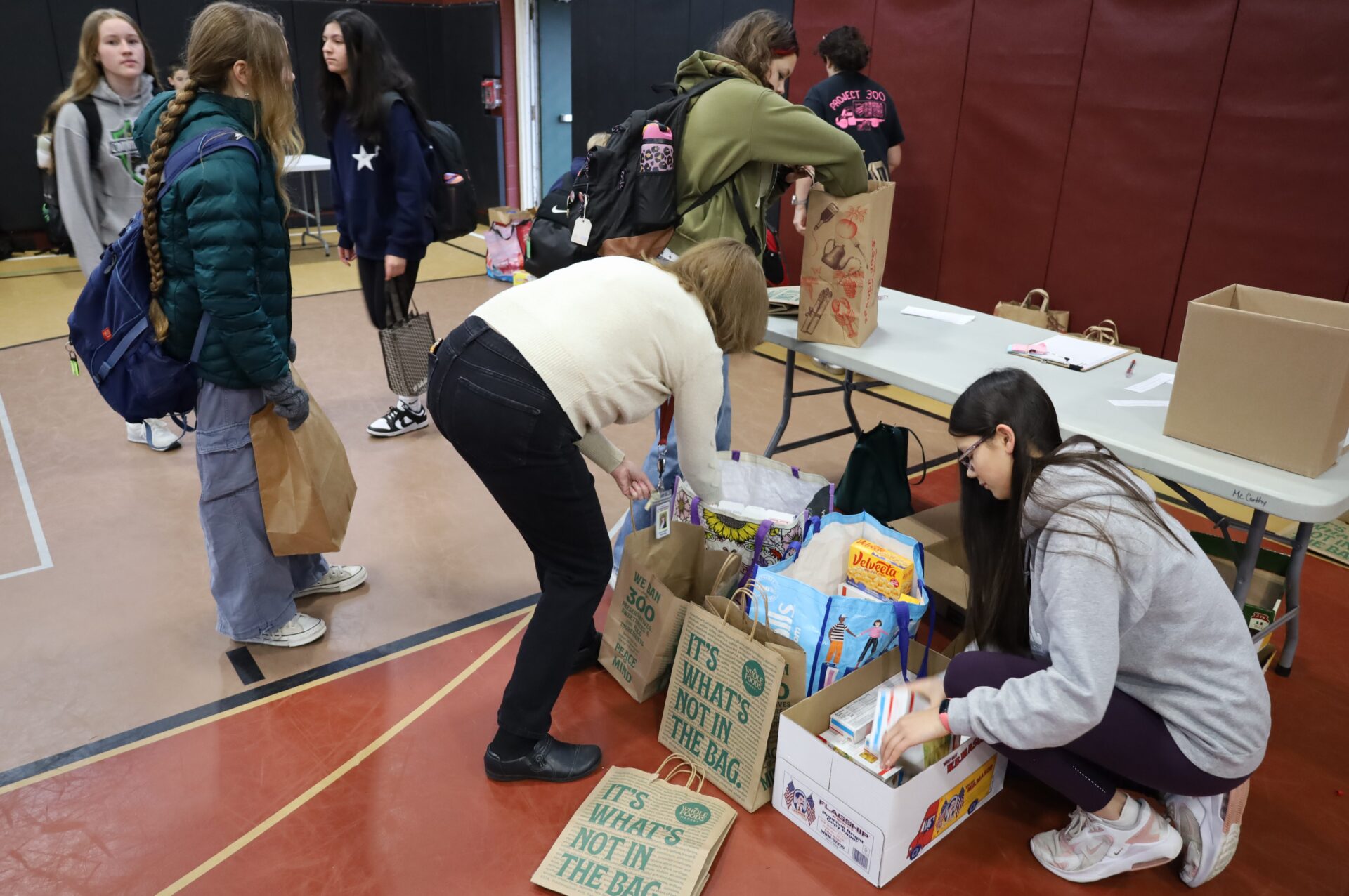 Students bring in non-perishable food items for the annual Project 300 donation drive at McCarthy Middle School in Chelmsford on Thursday, January 15, 2026.