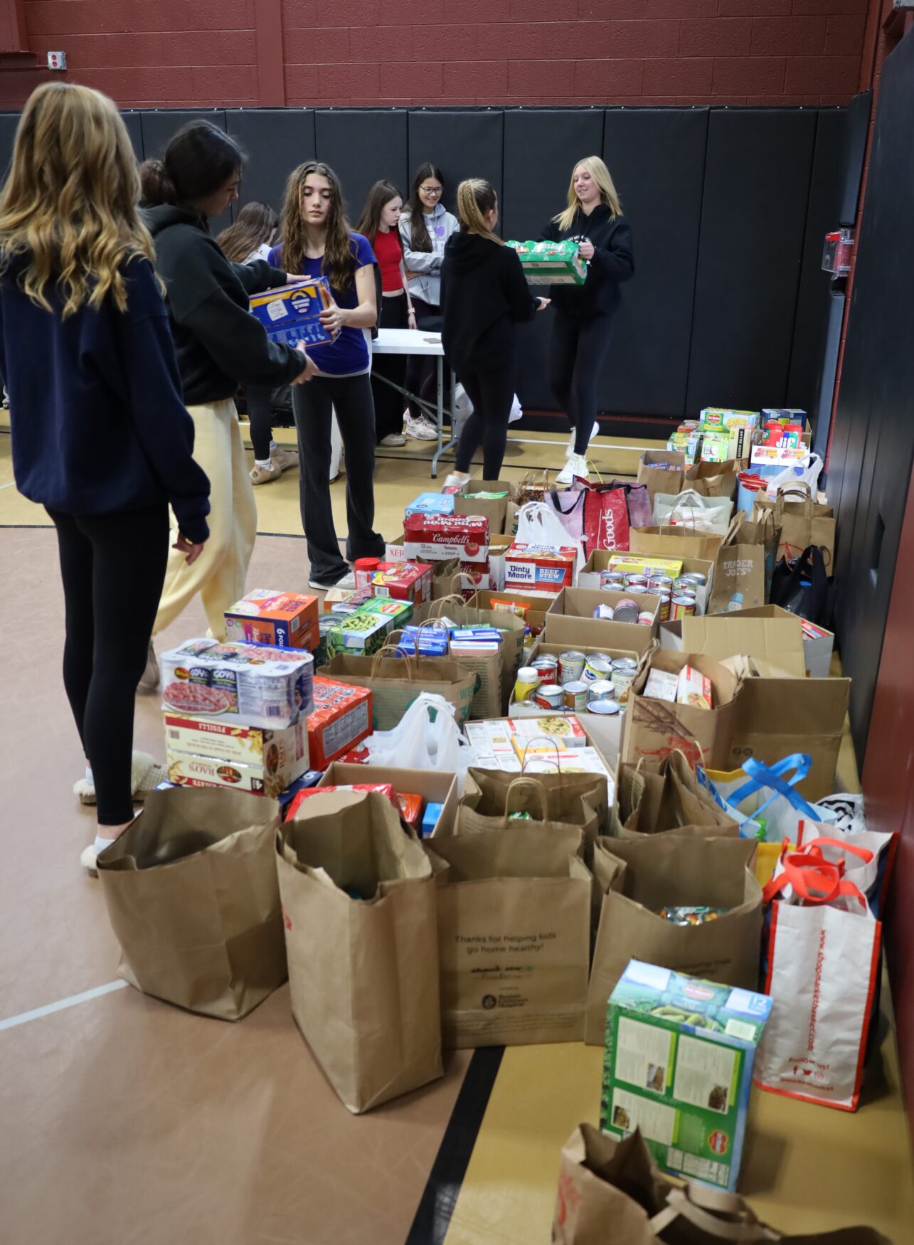 Students help count and organize Project 300 donations in the small gym at McCarthy Middle School on Thursday, January 15, 2026.